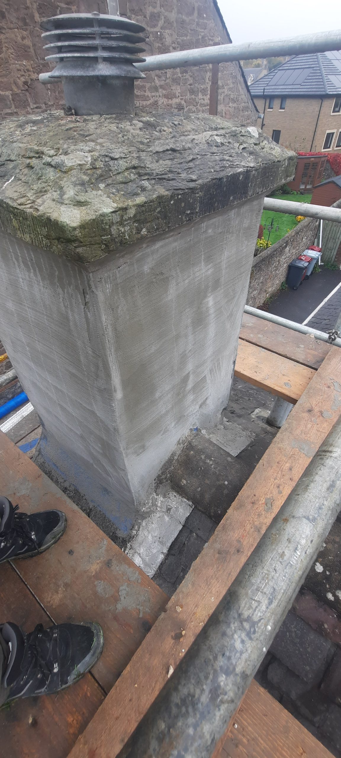 roughcaster Edinburgh working on chimney base rendering