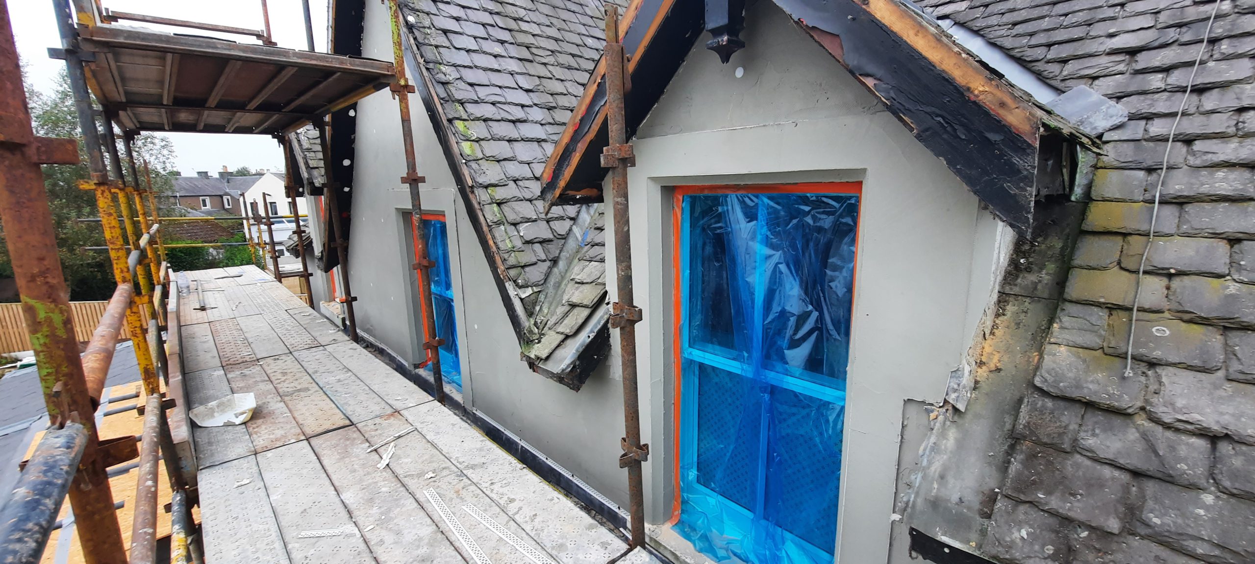 roughcast render Edinburgh beside pitched roof dormer