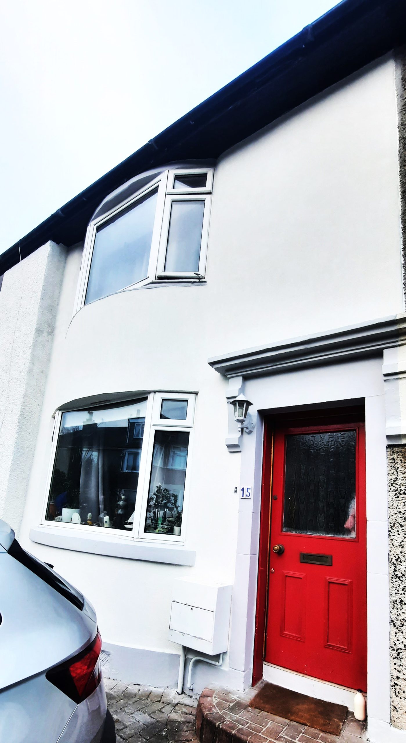 house rendering Edinburgh beside red entrance door