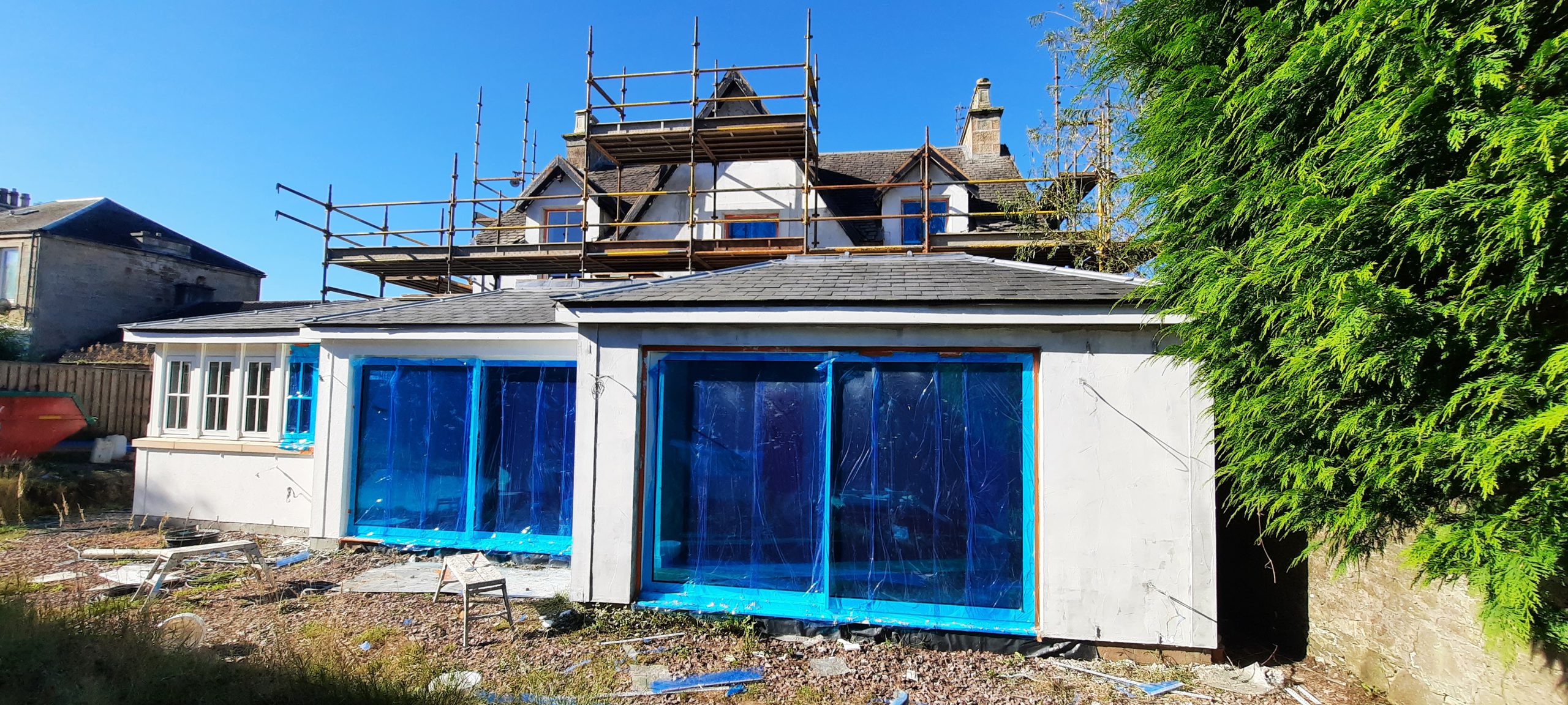 roughcasting Edinburgh on rear extension with large window
