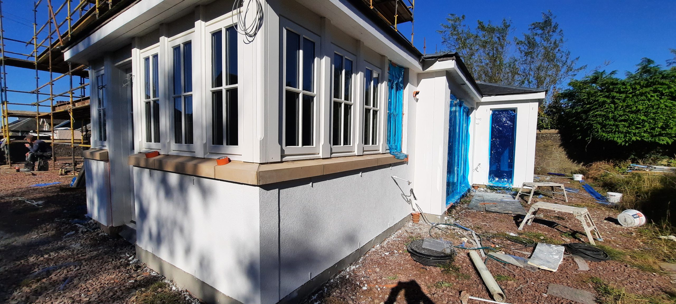 roughcast render repair beneath bay window ledge