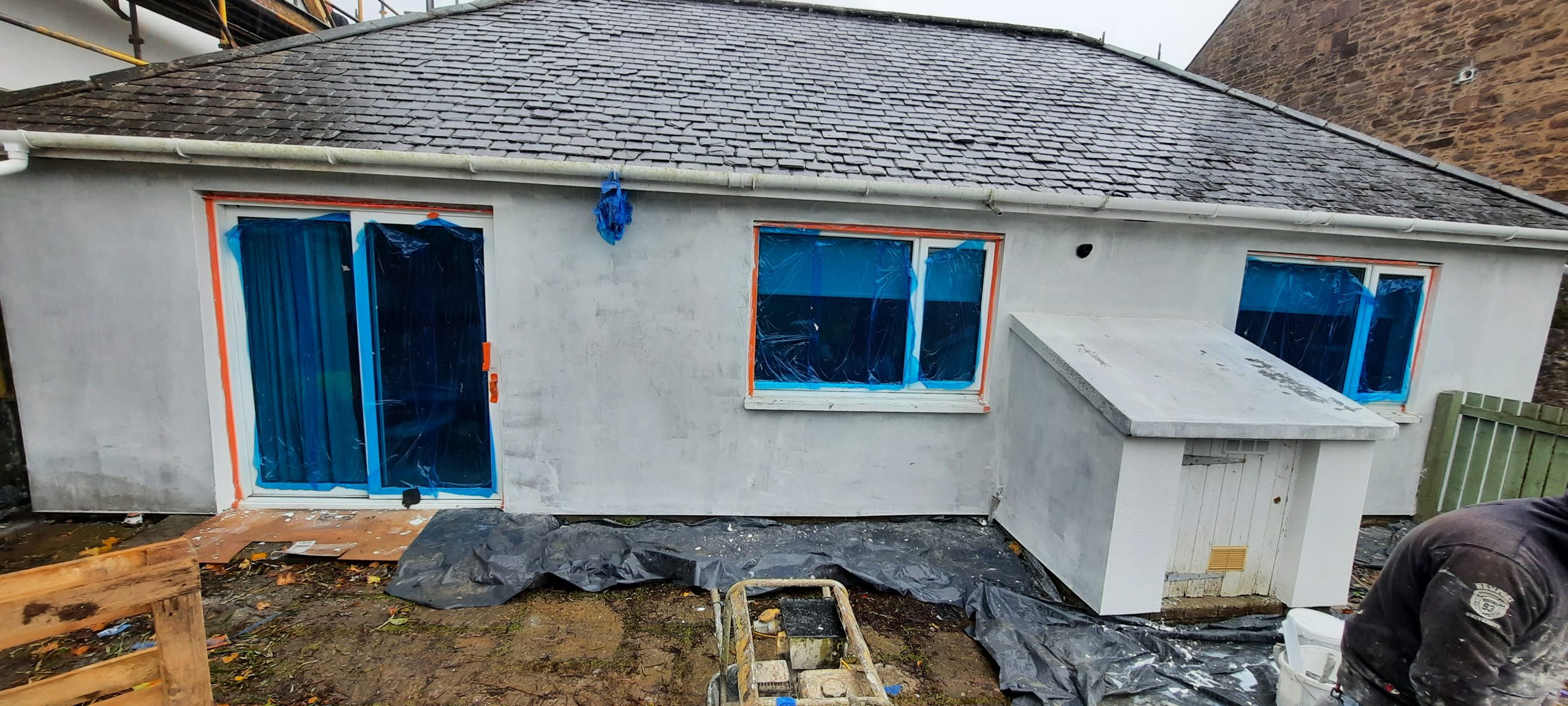 roughcast repair beneath freshly painted eaves