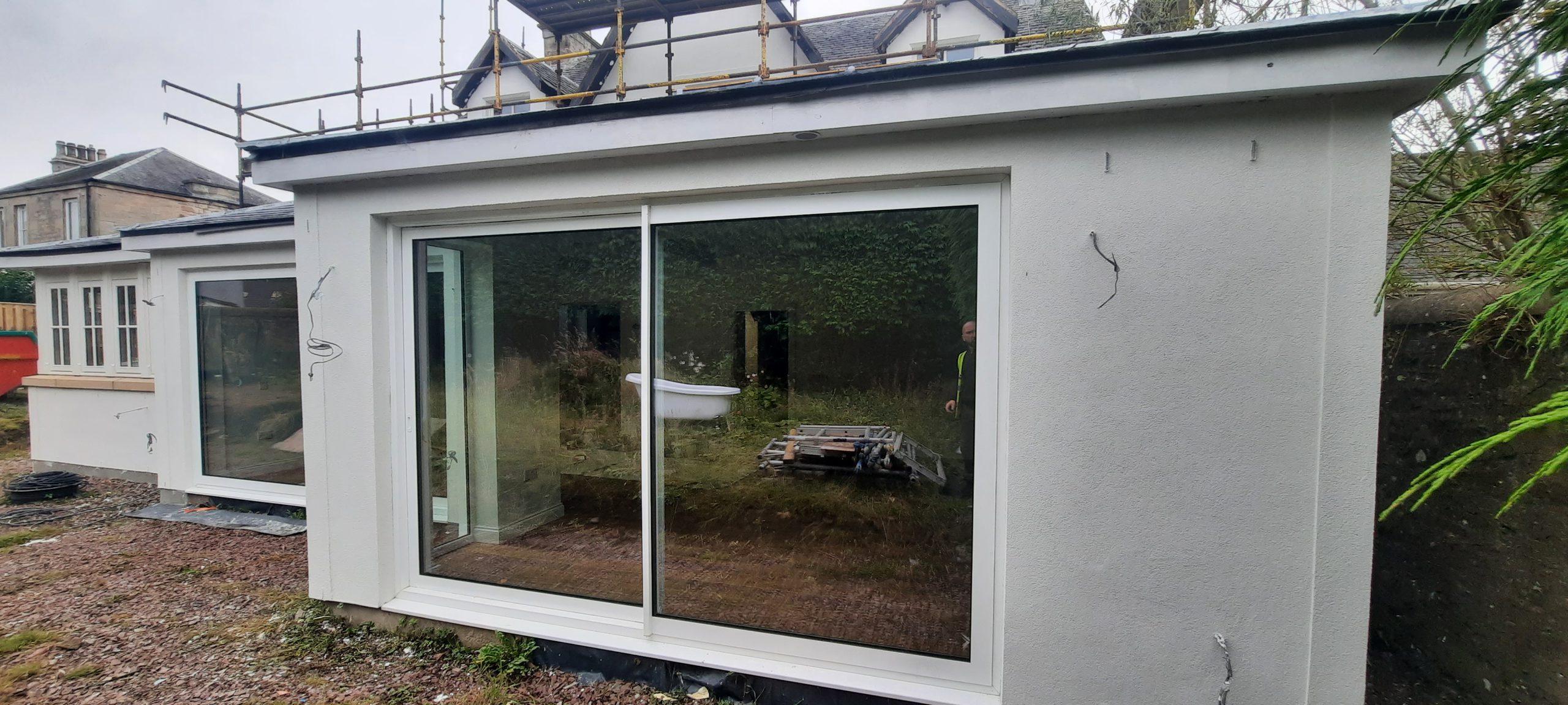 roughcast render repair around large glass patio door