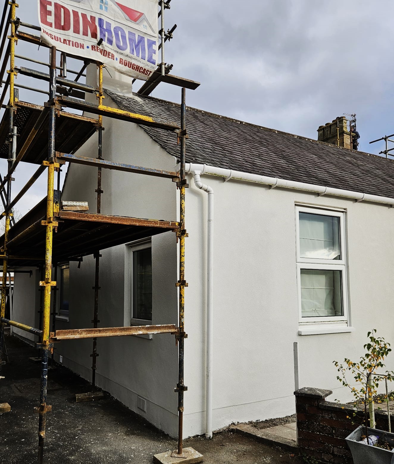 roughcast render repair on bright bungalow side