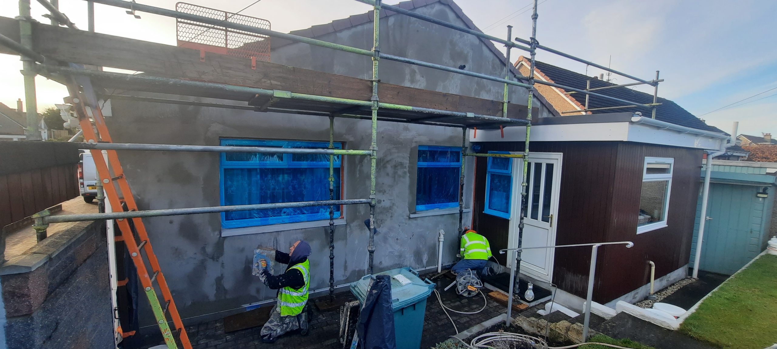 roughcast repair applied to gable wall with porch